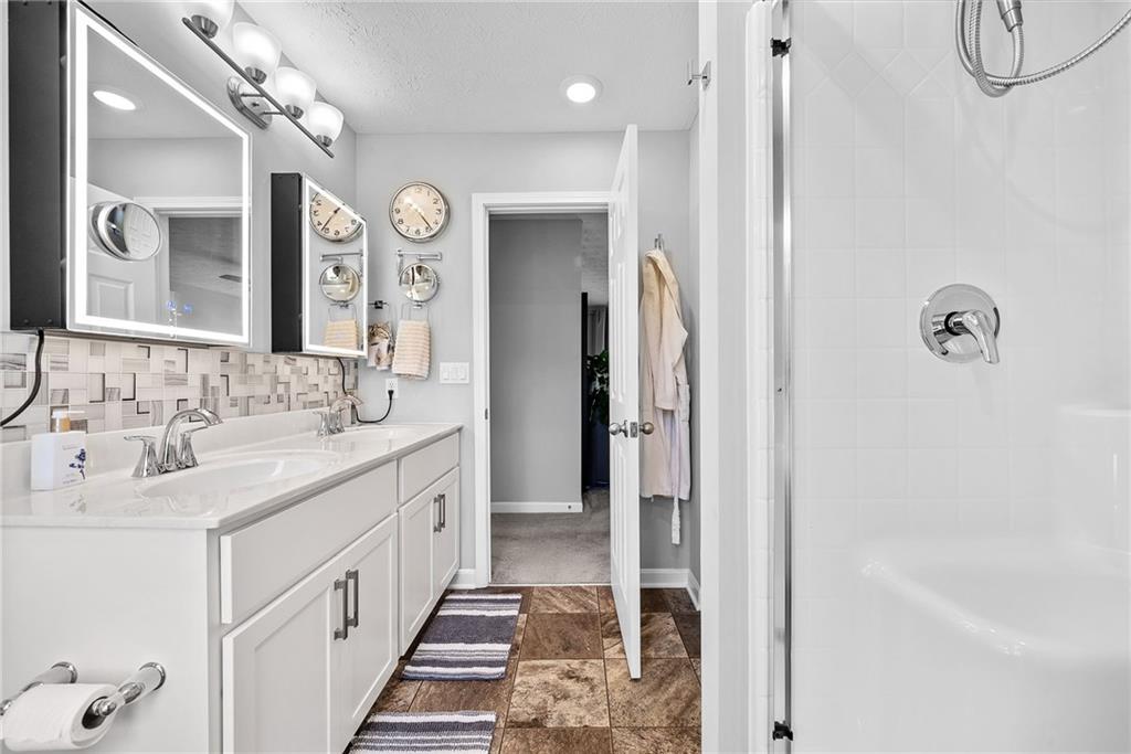 264 Lily Ridge Drive Canonsburg, PA 15317 - Photo 32 of 50 a spacious bathroom with a double vanity sink a large mirror a shower and bathtub