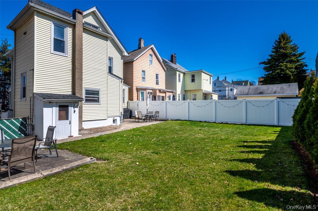 92 Washington Avenue, Unit 1 New Rochelle, NY 10801 - Photo 19 of 24 Back of property featuring a patio, a fenced backyard, and a residential view