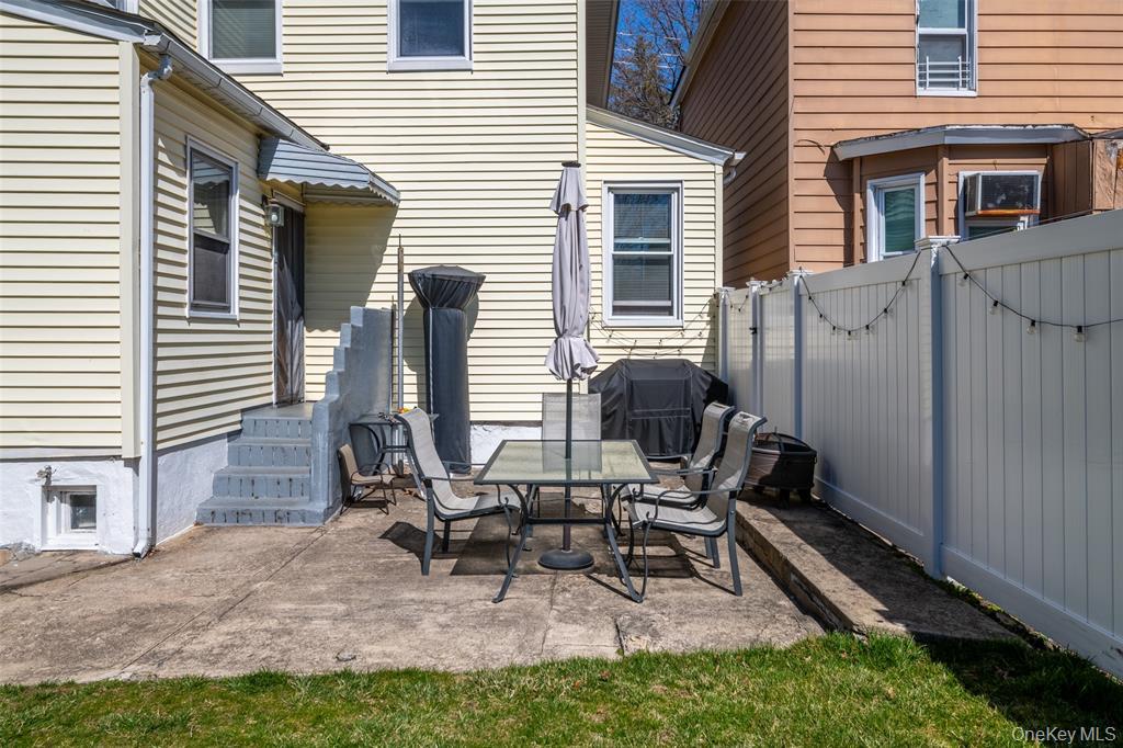 92 Washington Avenue, Unit 1 New Rochelle, NY 10801 - Photo 20 of 24 View of patio featuring a gate, grilling area, and outdoor dining area