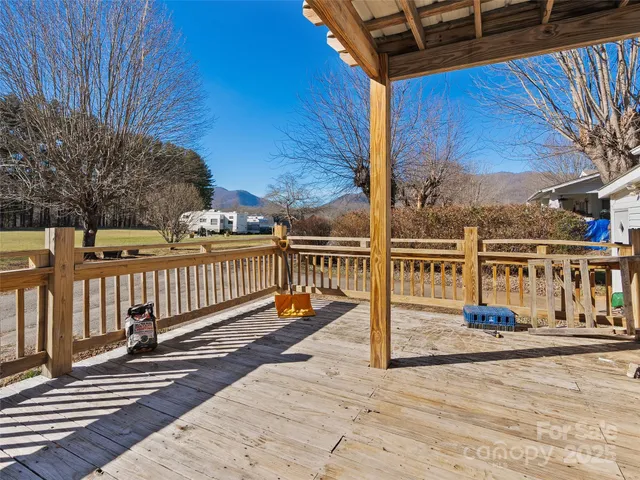 a view of a balcony with wooden floor and fence