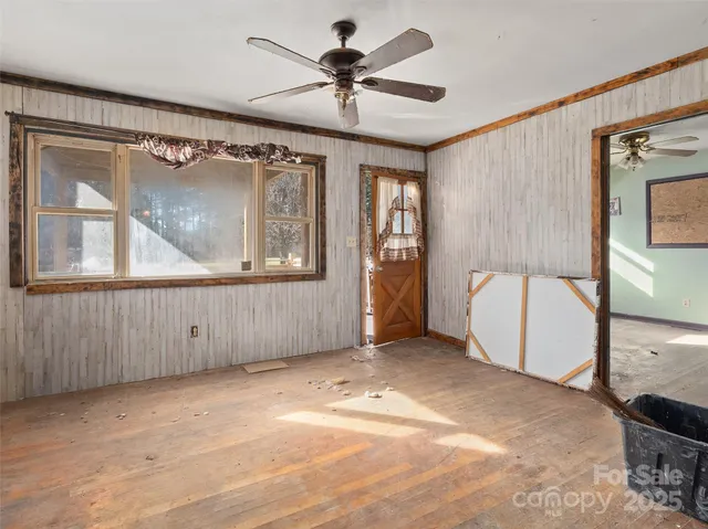 a view of a livingroom with a ceiling fan and window