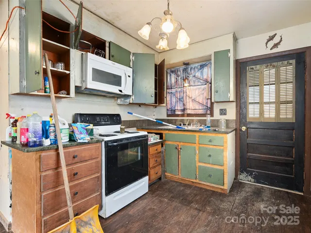 a kitchen with stainless steel appliances granite countertop a sink and cabinets