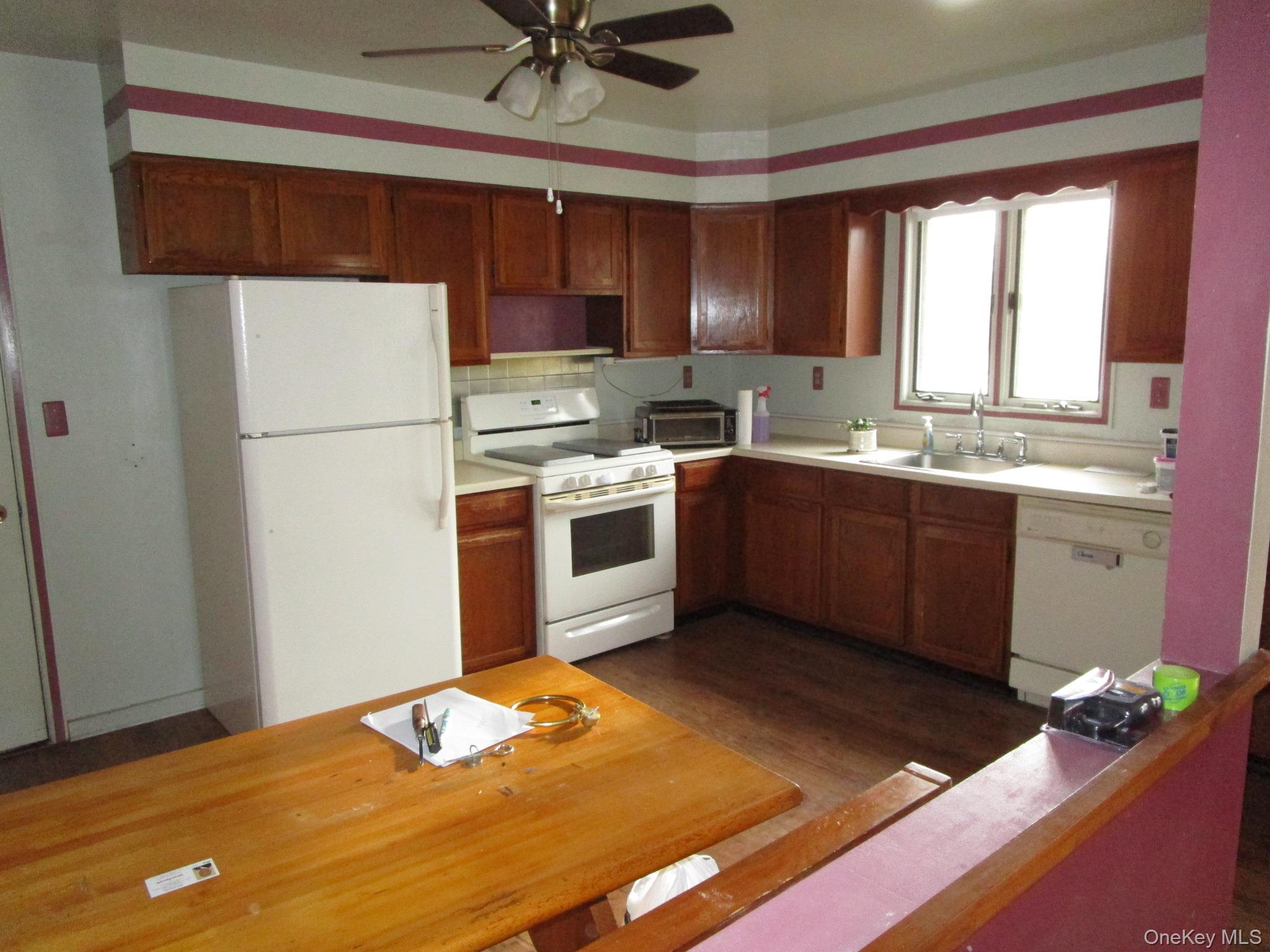 69 County Rte 93 New Hampton, NY 10958 - Photo 4 of 25 a kitchen with a sink cabinets stainless steel appliances and a window