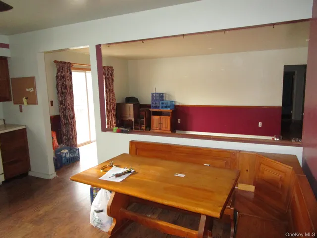a room with furniture pool table and wooden floor