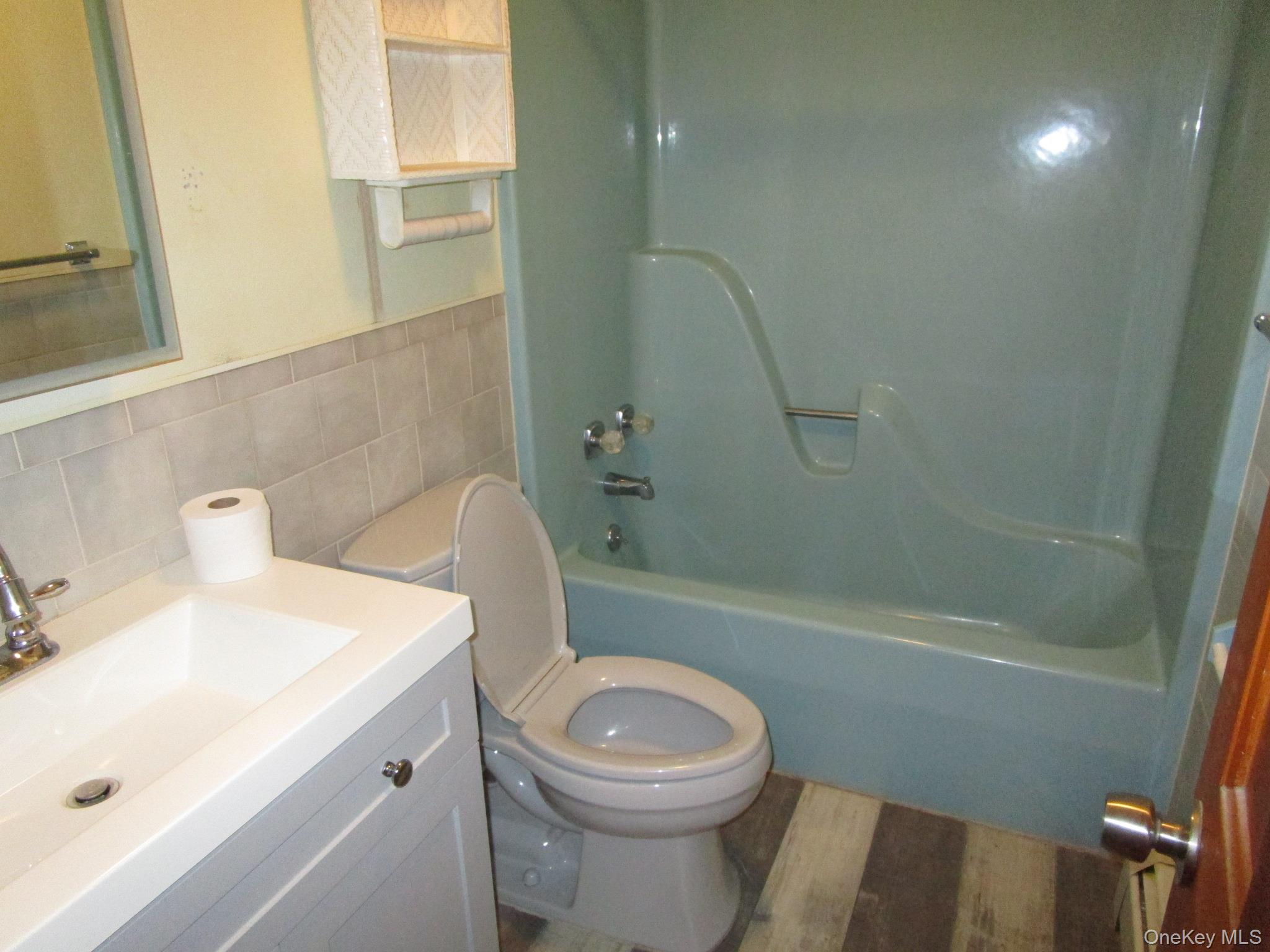69 County Rte 93 New Hampton, NY 10958 - Photo 10 of 25 a white toilet sitting next to a bath tub