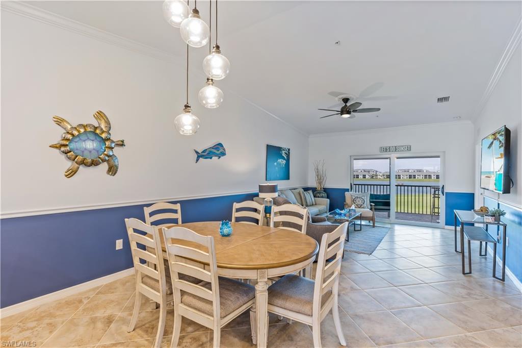 15990 Grassland Lane, Unit 3025 Babcock Ranch, FL 33982 - Photo 13 of 14 a dining room with furniture a rug a potted plant and a chandelier