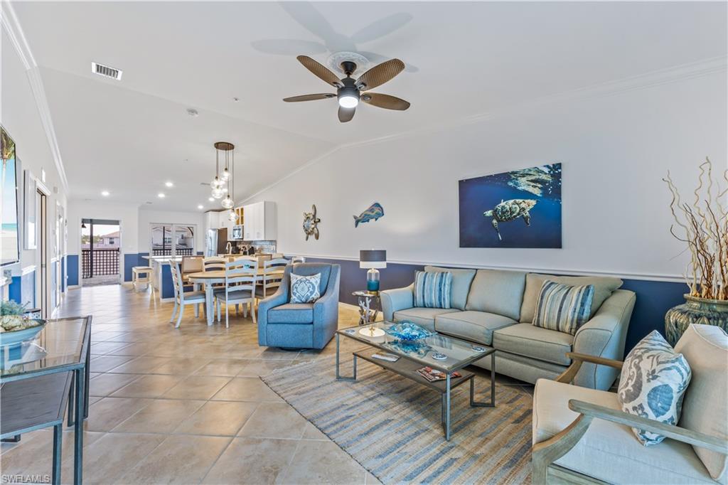 15990 Grassland Lane, Unit 3025 Babcock Ranch, FL 33982 - Photo 3 of 14 a living room with furniture kitchen view and a chandelier