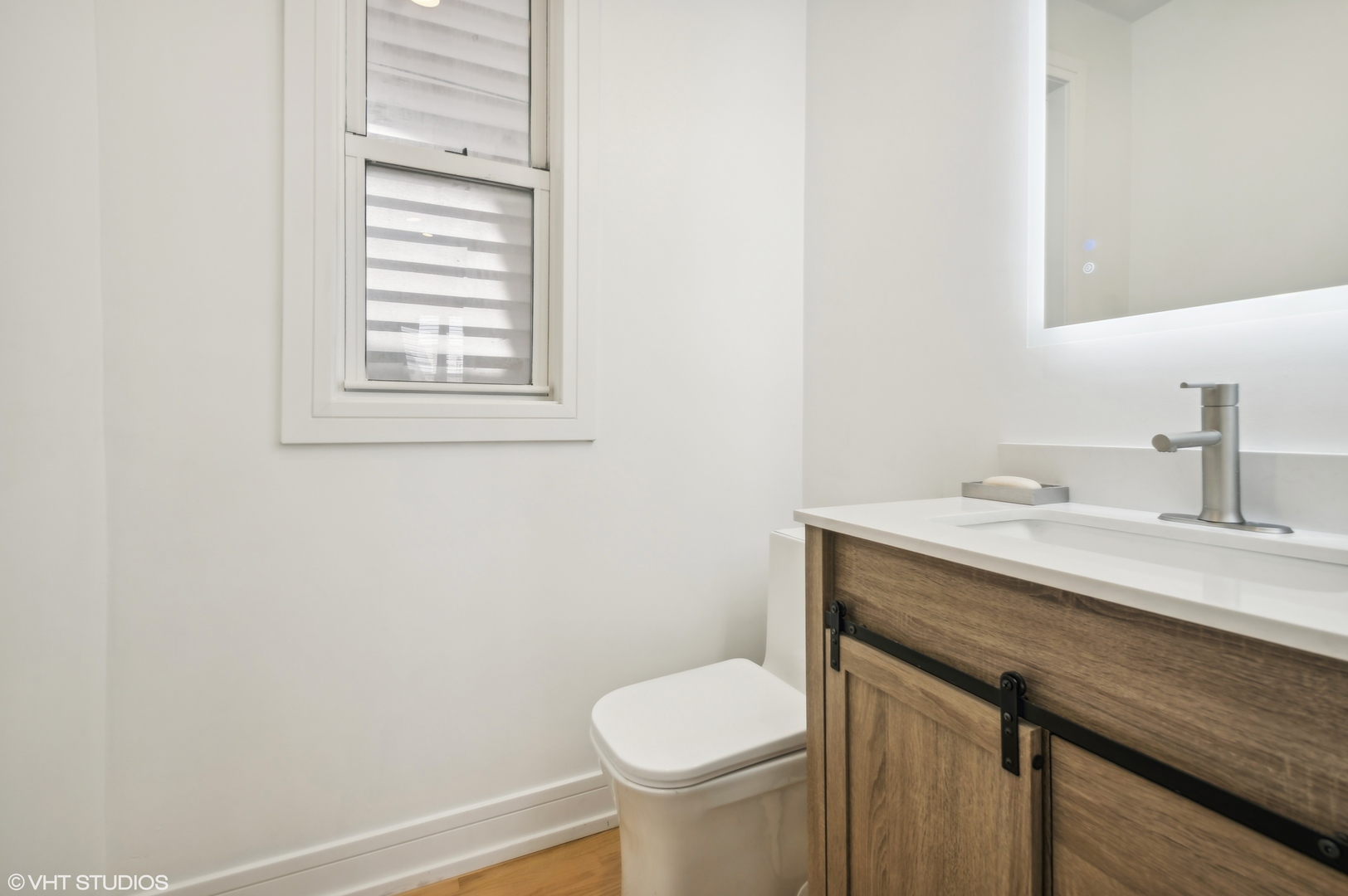 4110 North Kenneth Avenue Chicago, IL 60641 - Photo 16 of 28 a bathroom with a granite countertop toilet sink and mirror