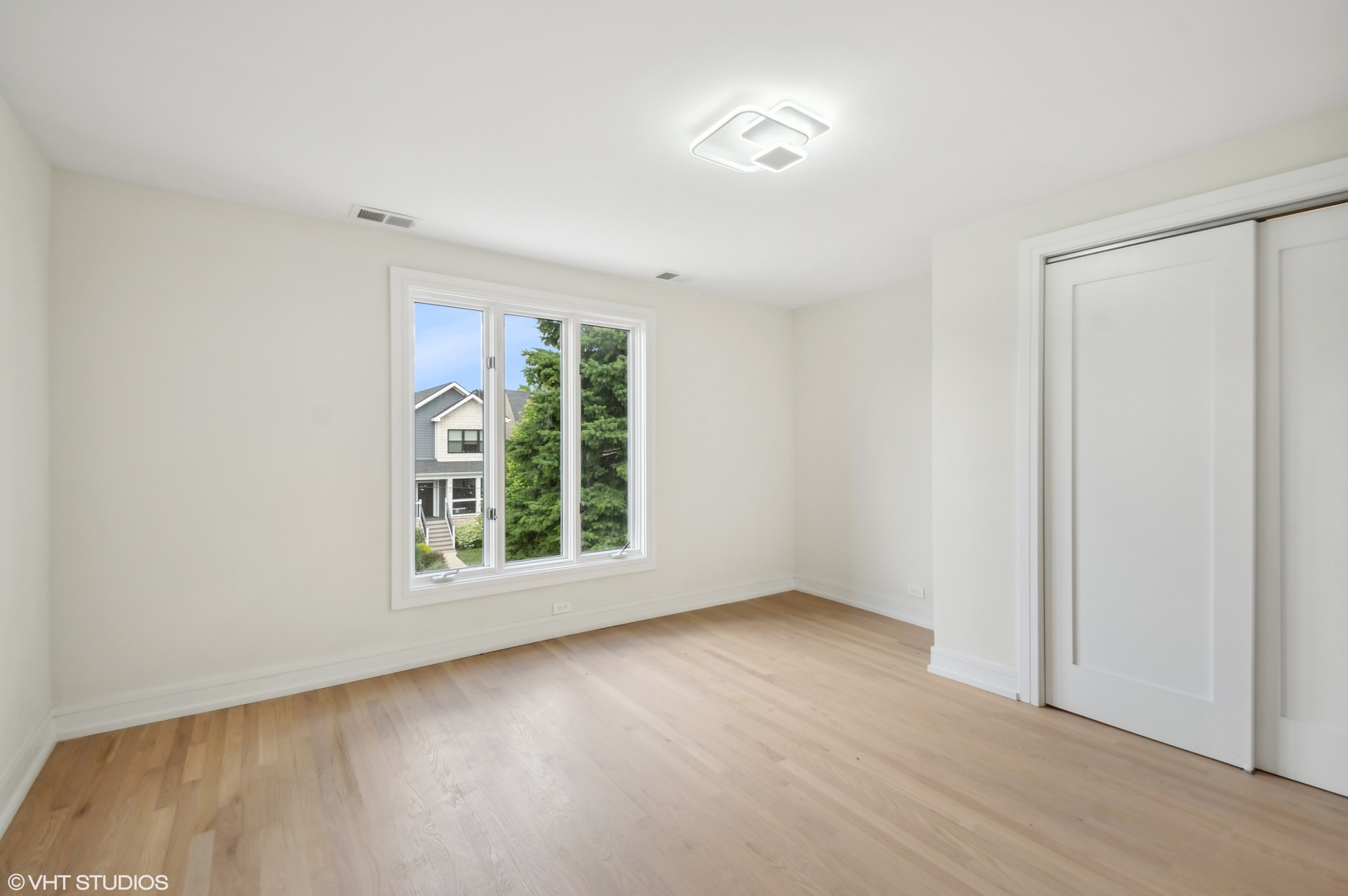 4110 North Kenneth Avenue Chicago, IL 60641 - Photo 18 of 28 an empty room with wooden floor and windows