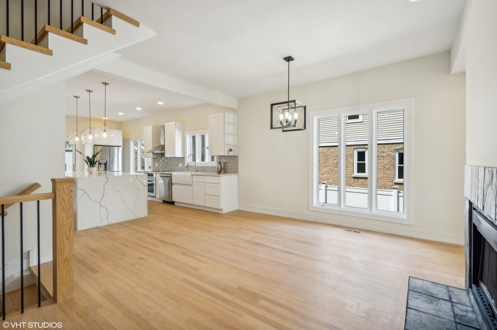 4110 North Kenneth Avenue Chicago, IL 60641 - Photo 6 of 28 a view of a kitchen with a sink cabinet and a living room