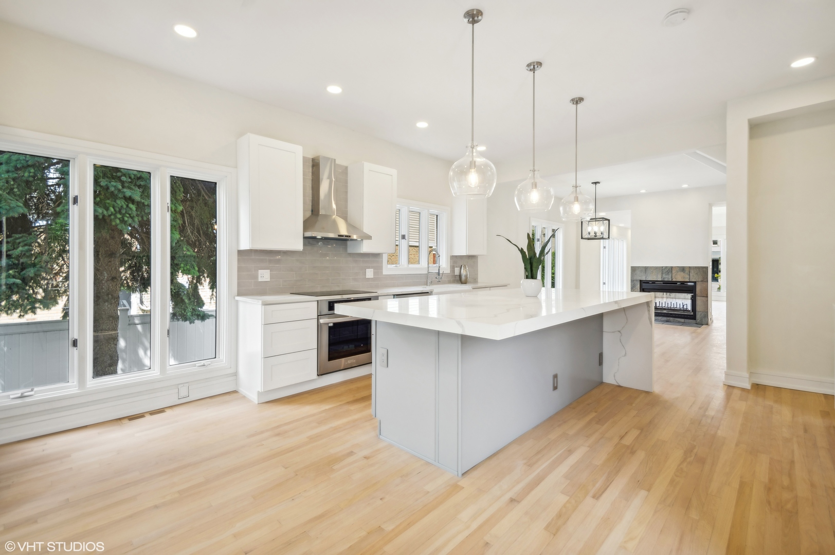 4110 North Kenneth Avenue Chicago, IL 60641 - Photo 7 of 28 a large white kitchen with a large window and stainless steel appliances