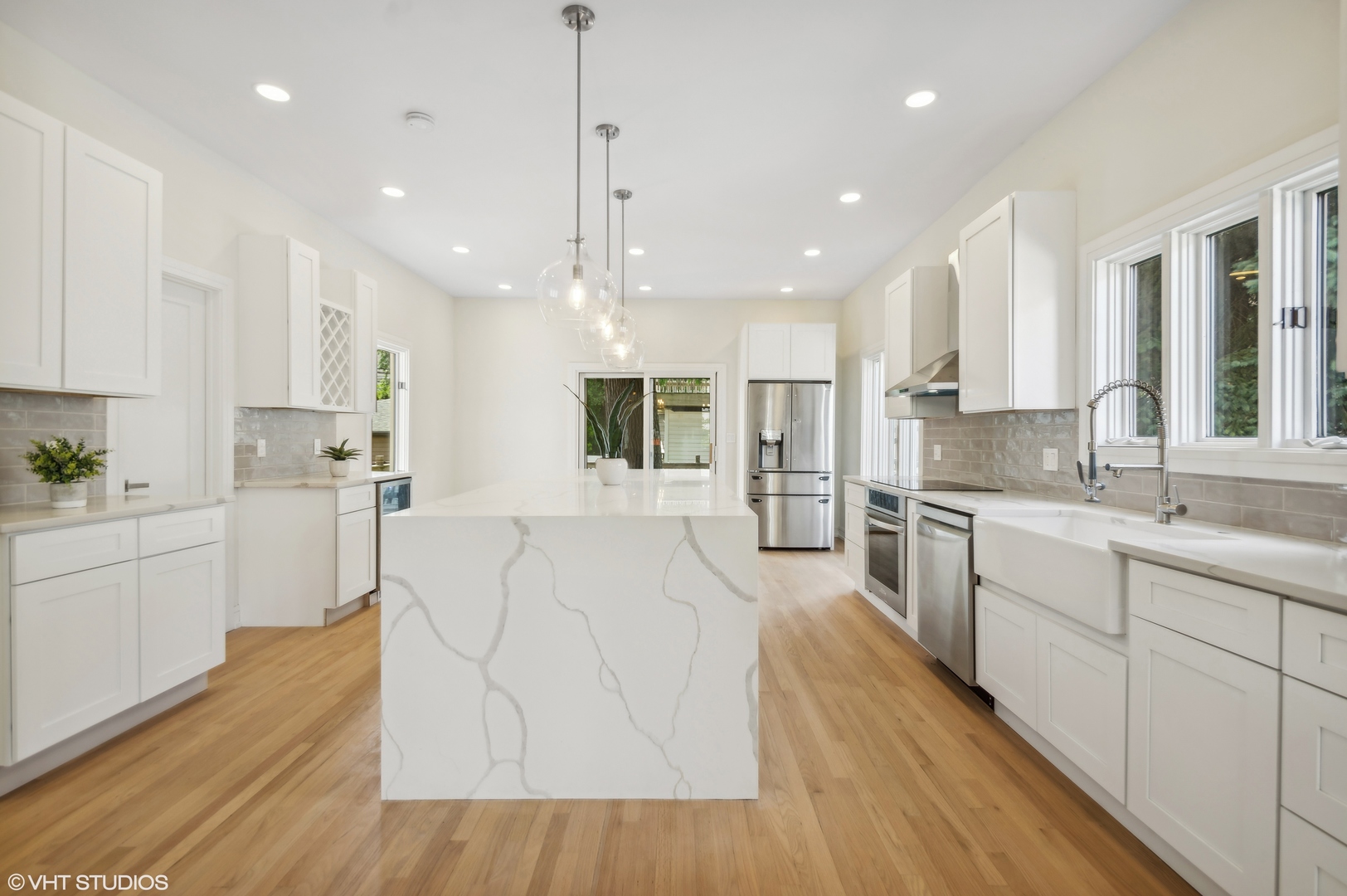 4110 North Kenneth Avenue Chicago, IL 60641 - Photo 8 of 28 a large kitchen with stainless steel appliances kitchen island a large counter top and a wooden floors