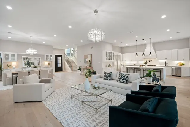 a large kitchen with kitchen island a sink a table and a chairs