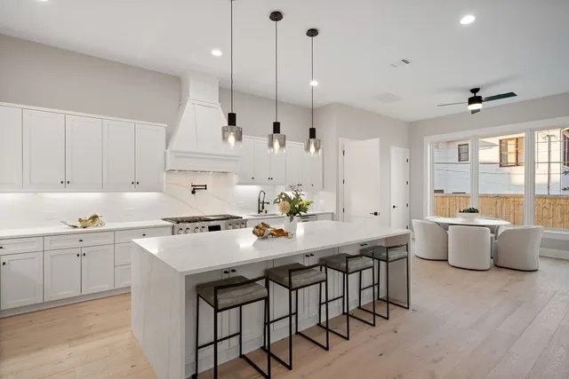 a living room with furniture a large window and a chandelier
