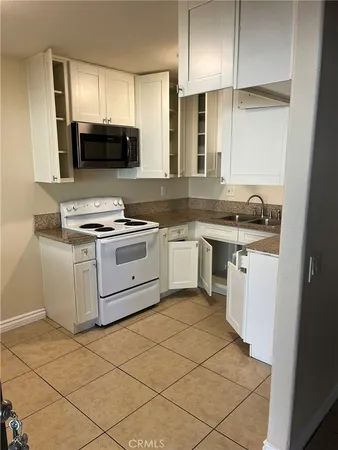a kitchen with a stove a sink and a refrigerator