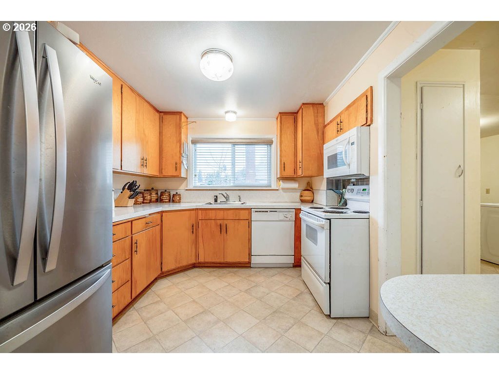190 Hunsaker Lane Eugene, OR 97404 - Photo 13 of 28 a kitchen with white cabinets and white appliances