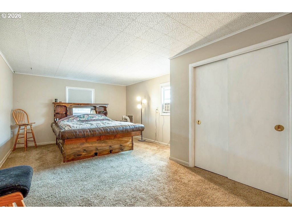 190 Hunsaker Lane Eugene, OR 97404 - Photo 19 of 28 a bedroom with a bed and a table