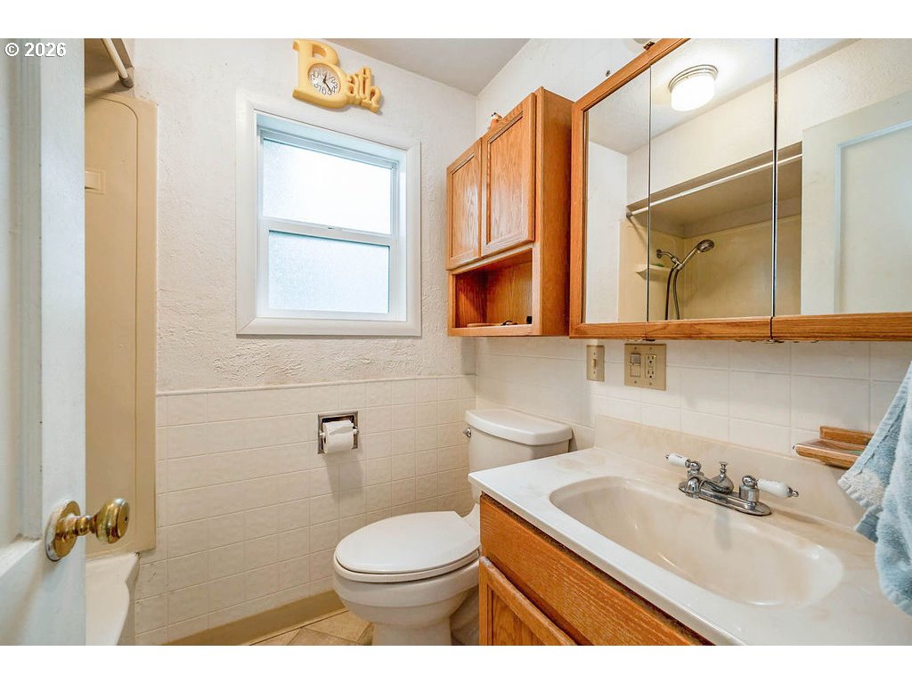 190 Hunsaker Lane Eugene, OR 97404 - Photo 20 of 28 a bathroom with a granite countertop sink mirror vanity and toilet