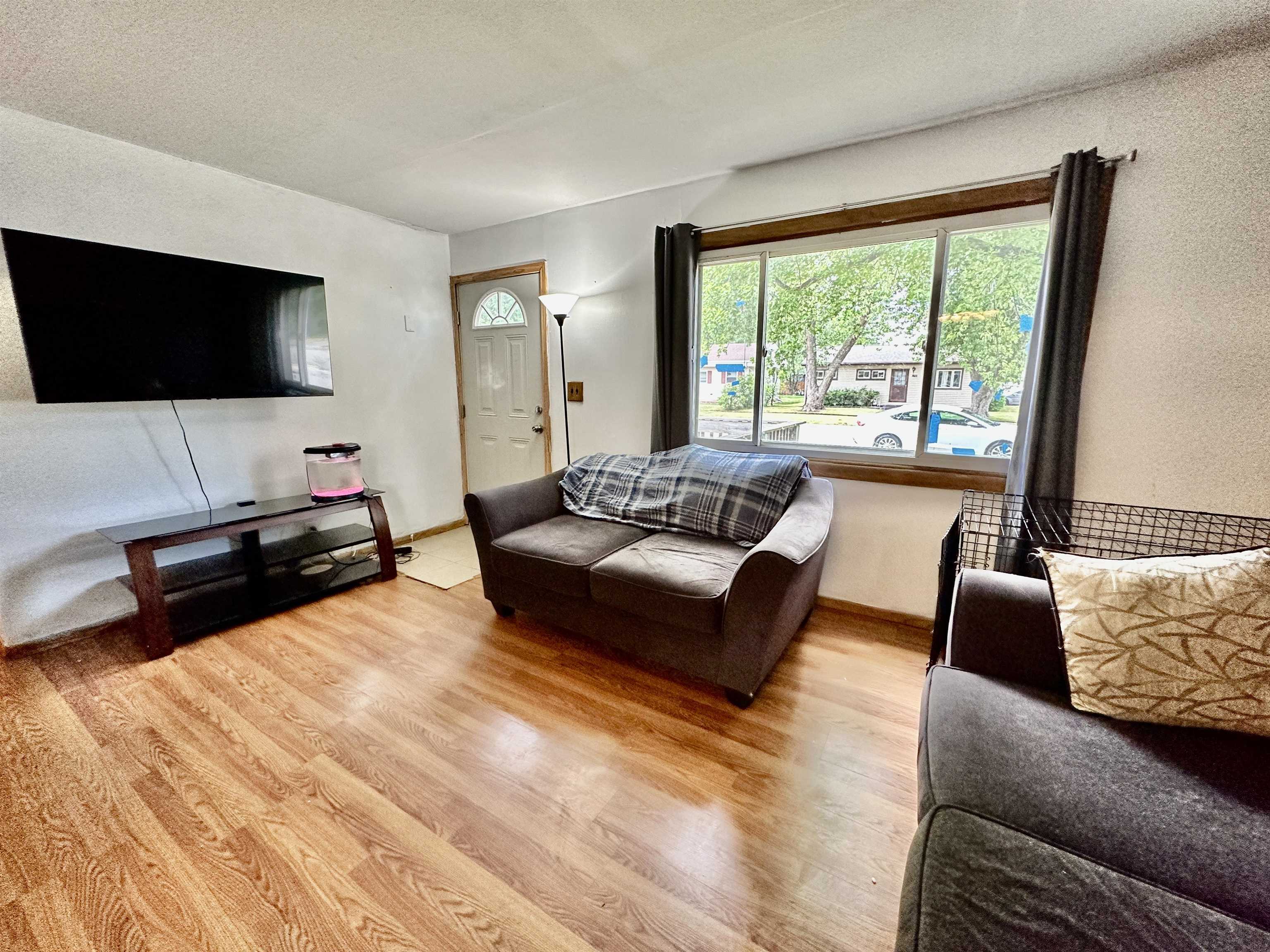 7611 Randy Road Machesney Park, IL 61115 - Photo 5 of 16 a living room with furniture and a flat screen tv
