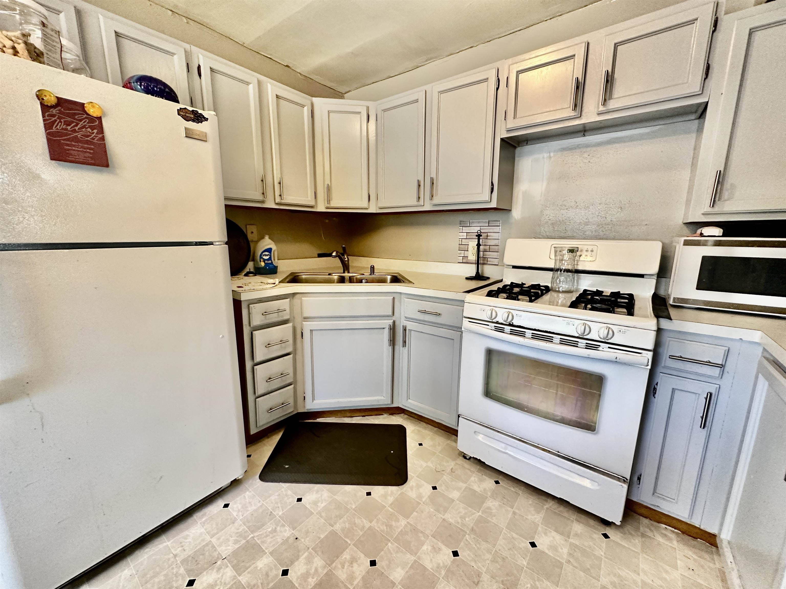 7611 Randy Road Machesney Park, IL 61115 - Photo 8 of 16 a kitchen with white cabinets and white appliances