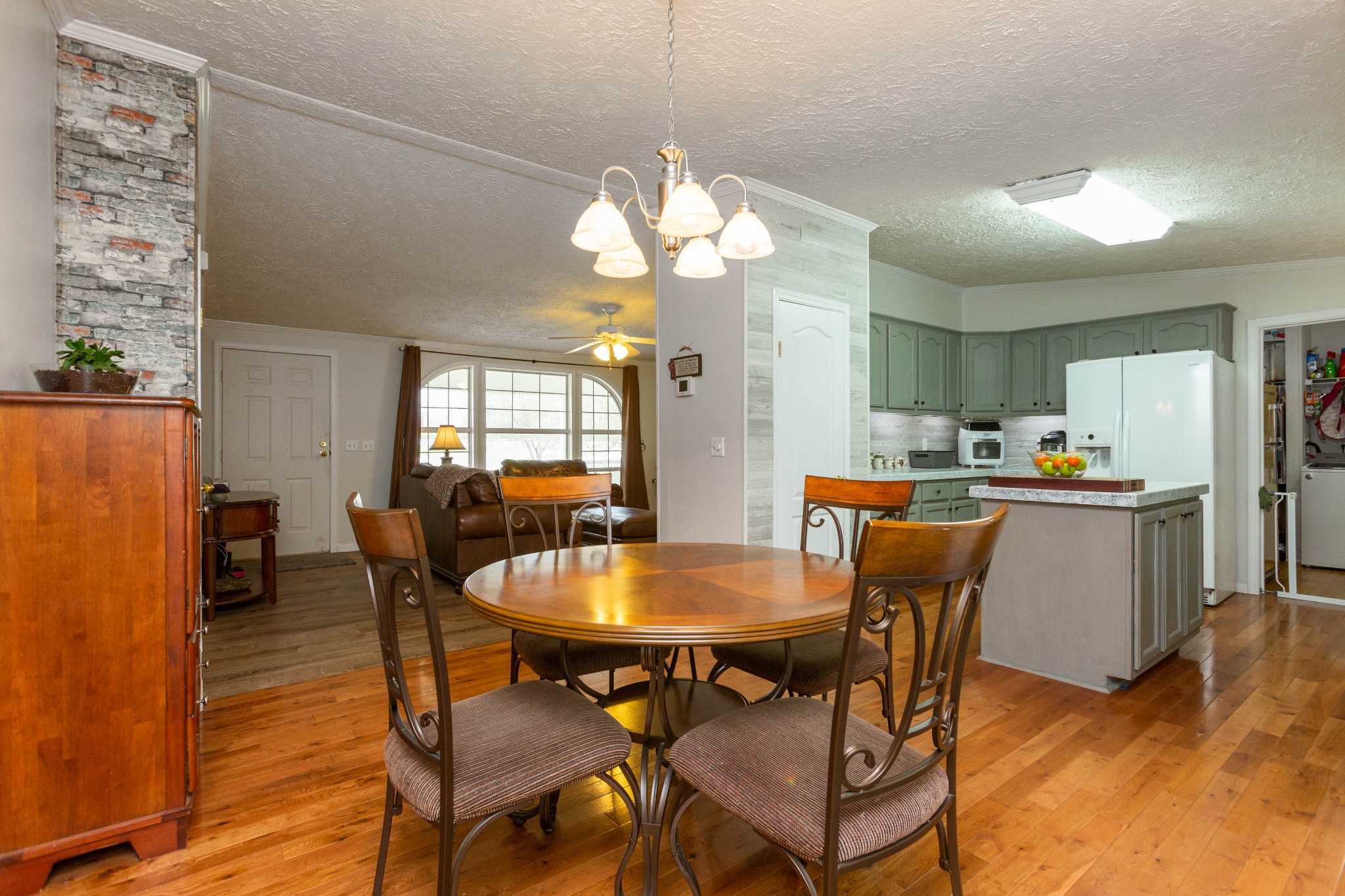 5425 Ashburn Road Springfield, TN 37172 - Photo 14 of 40 a dining room with furniture a chandelier and wooden floor
