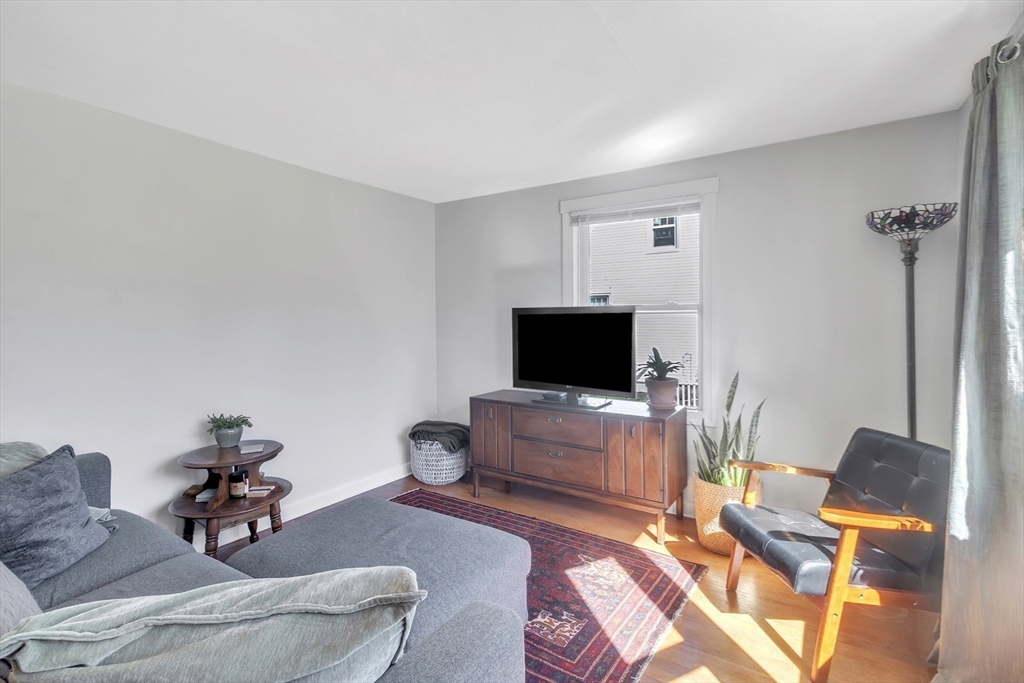 78 Mayflower Road Springfield, MA 01118 - Photo 8 of 27 a living room with furniture and a flat screen tv