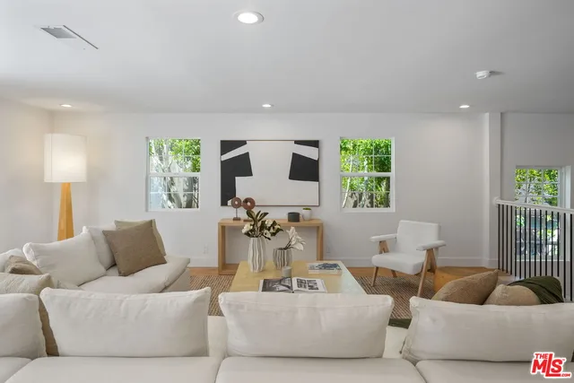a living room with furniture and kitchen view