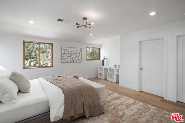a bathroom with a double vanity sink and a large mirror next to a window