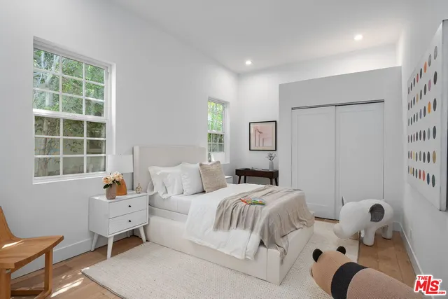 a bathroom with a toilet a sink a tub and mirror