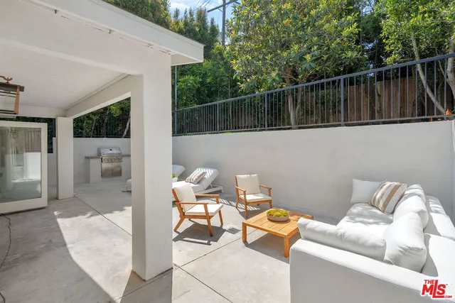 a view of a house with backyard and deck