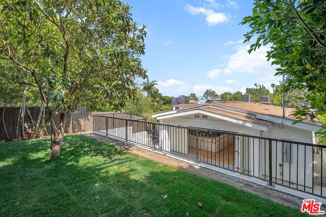 a view of a patio with table and chairs with wooden fence and plants