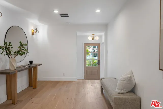 a living room with furniture a fireplace and a large window