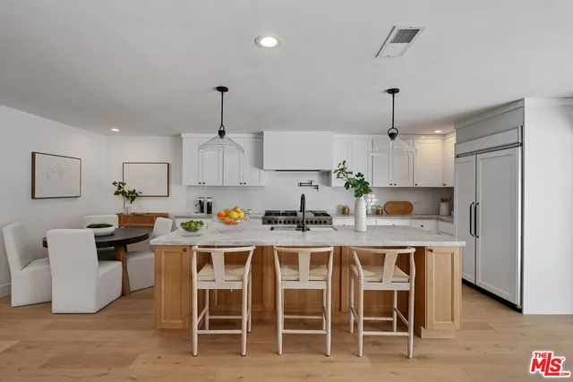 a kitchen with a dining table and chairs