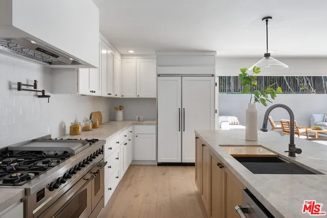 a living room with furniture kitchen and a table