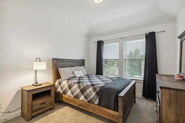 a bathroom with a sink a toilet a mirror and shower curtain