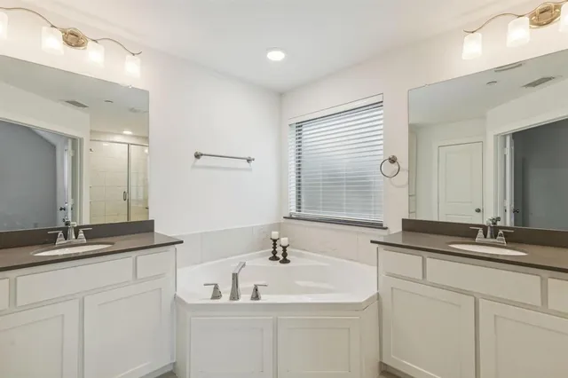 a bathroom with a granite countertop sink mirror and double