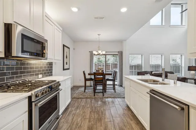 a kitchen with a sink and a stove top oven