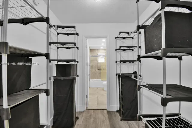 a view of a kitchen with refrigerator and cabinets