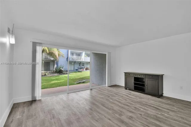 a view of room with window and hardwood floor