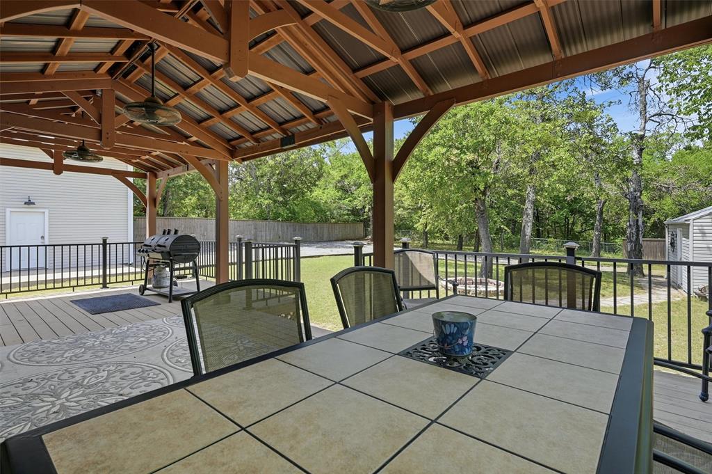 212 Sunset Road Pottsboro, TX 75076 - Photo 25 of 40 a view of a patio with a table chairs and a barbeque