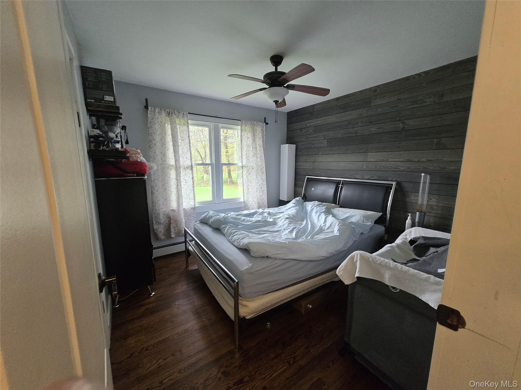 234 Sinsabaugh Road Pine Bush, NY 12566 - Photo 7 of 15 a bedroom with a bed and a chandelier