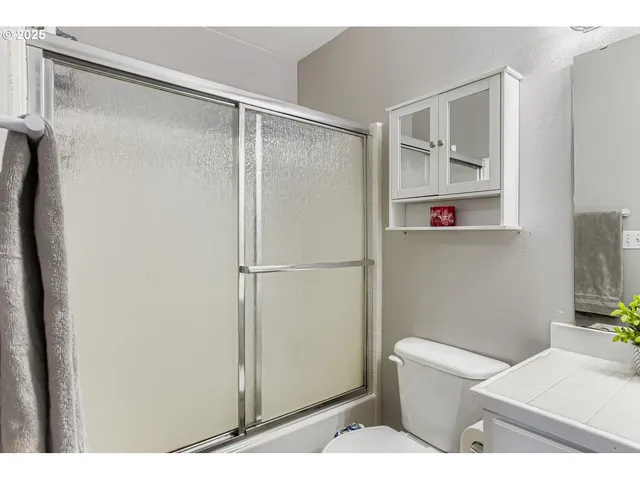 a bathroom with a shower toilet and sink