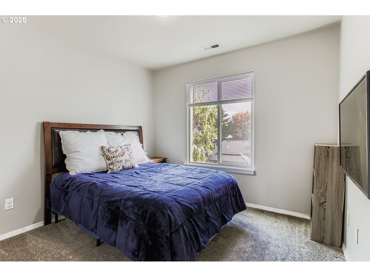 3138 Southwest 177th Place Beaverton, OR 97003 - Photo 18 of 28 a bedroom with a bed window and a table