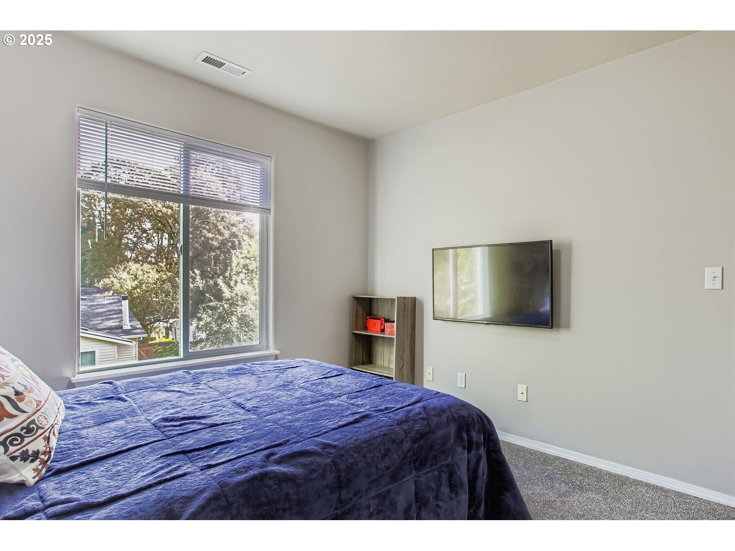 3138 Southwest 177th Place Beaverton, OR 97003 - Photo 19 of 28 a bedroom with a bed and a flat screen tv