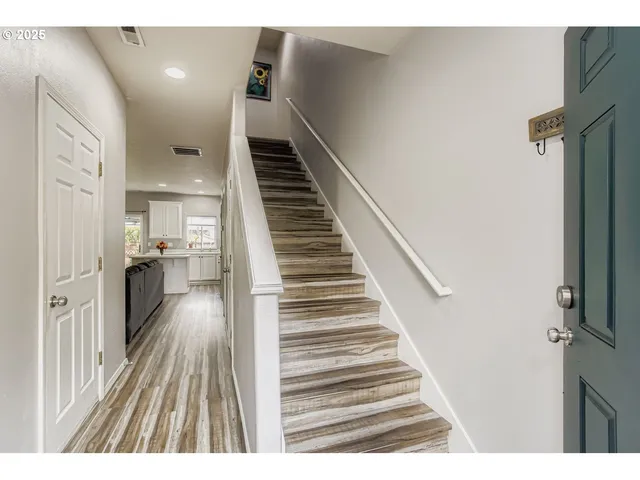 a view of entryway and hall with wooden floor