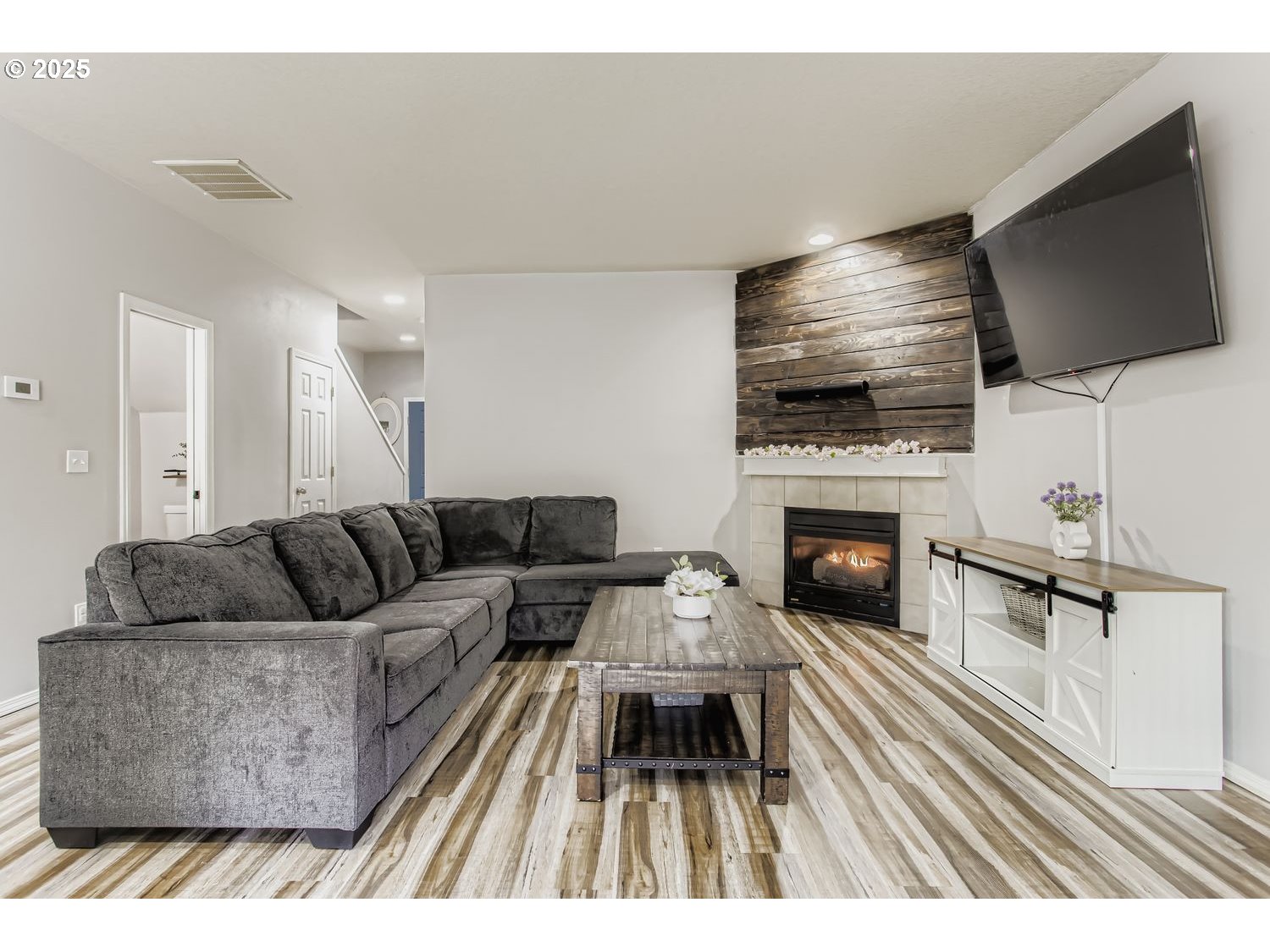 3138 Southwest 177th Place Beaverton, OR 97003 - Photo 5 of 28 a living room with furniture a flat screen tv and a fireplace