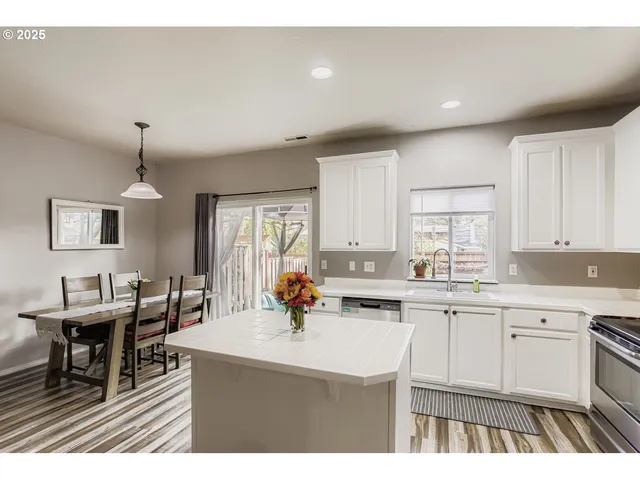 a kitchen with lots of counter top space and dining table