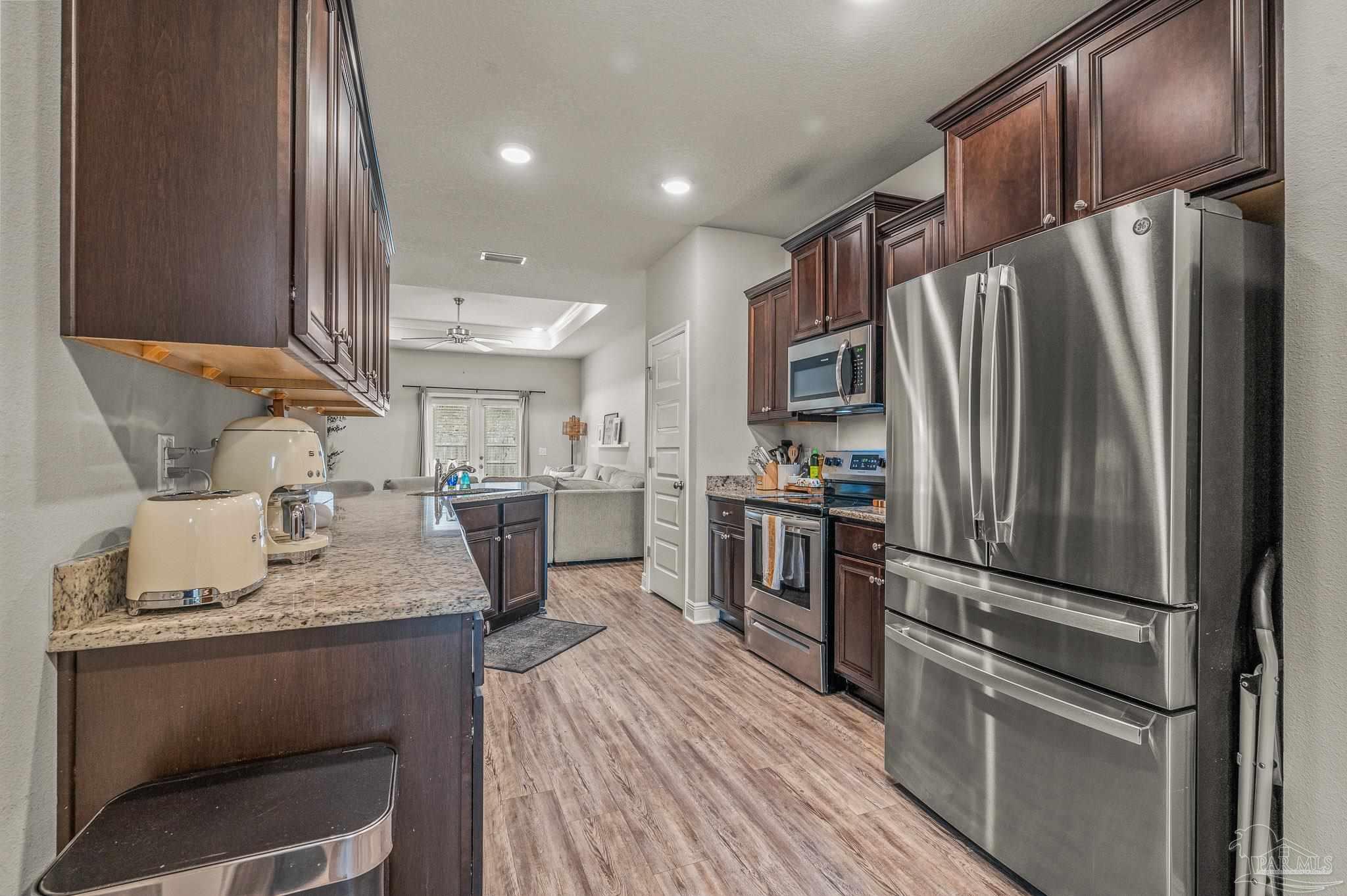 5329 Talon Road Pace, FL 32571 - Photo 11 of 45 a kitchen with kitchen island a counter top space stainless steel appliances and cabinets