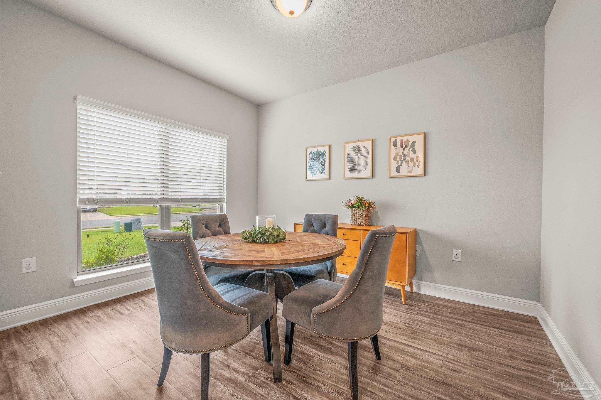 5329 Talon Road Pace, FL 32571 - Photo 18 of 45 a view of a dining room with furniture and wooden floor