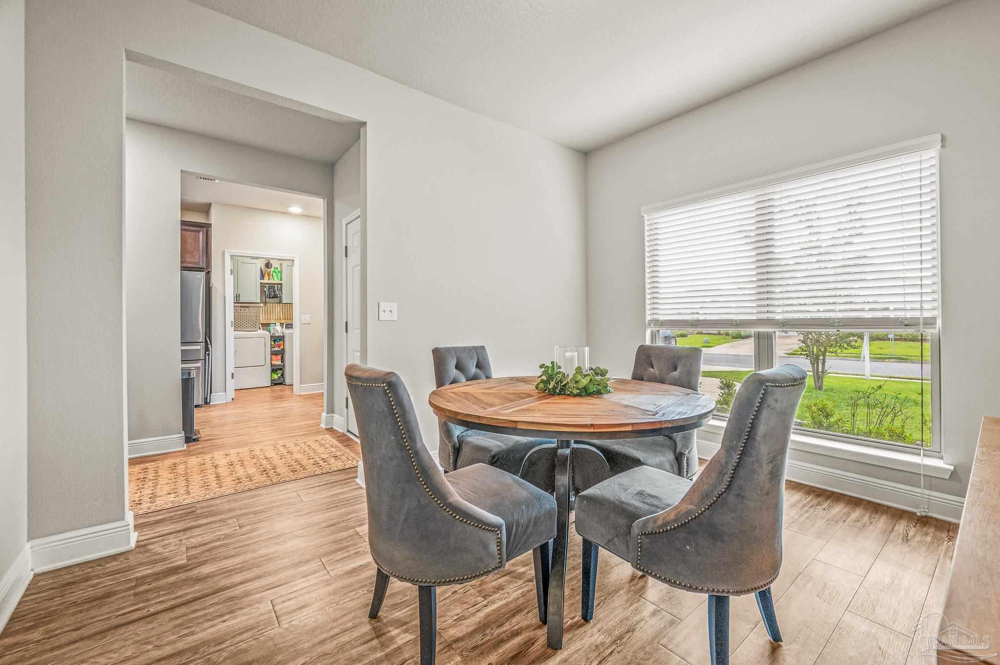 5329 Talon Road Pace, FL 32571 - Photo 19 of 45 a view of a dining room with furniture window and wooden floor